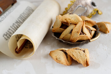 Scroll of Esther and haman's ears cookies. Concept Jewish holiday Purim.