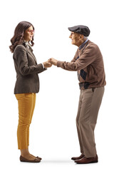 Full length profile shot of a young woman holding hands of an elderly man