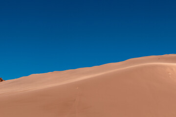 The landscape of golden sand dunes in The Atacama desert. Chile. Copy space. Wallpaper.