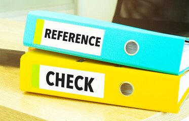 REFERENCE CHECKS on colourful folders on table