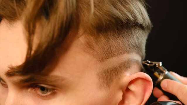 close up Shot of a handsome barber giving a haircu