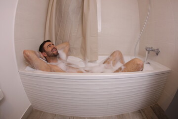 Handsome man taking a bath