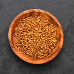 Trigonella foenum-graecum - Dried organic fenugreek seeds in the bowl