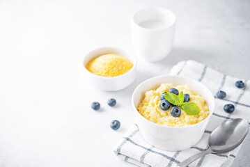 Corn porridge with fresh blueberries in a bowl