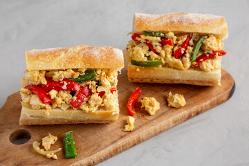 Homemade Easter Pepper and Egg Sandwich on a rustic wooden board, low angle view.