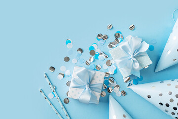 Blue gift boxes with confetti on blue background