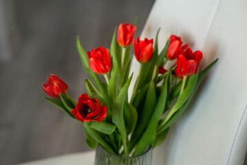 red tulips in a glass vase