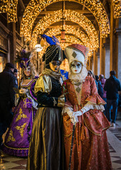 Fototapeta na wymiar People wearing elaborate masks and costumes during the Venice carnival 