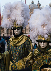 People wearing elaborate masks and costumes during the Venice carnival 