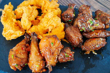 caramelized chicken with sesame and garlic, meat strips in breadin.