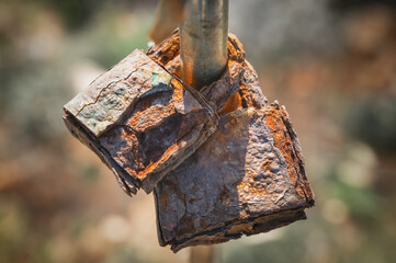 A couple of old rusty locks with a blurry background 