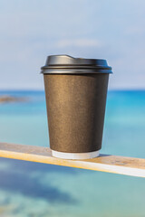 ''Add Words'' isolated take away coffee cup, with a  blurry beach background