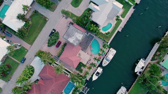 Aerial footage spinning above a canal with beautiful homes in south Florida