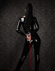 Sexy Dominant Woman in Latex Catsuit with Whip