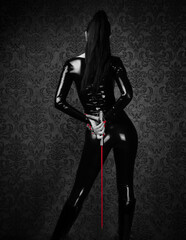 Sexy Dominant Woman in Latex Catsuit with Whip