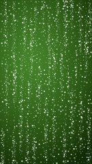 Magic falling snow christmas background. Subtle flying snow flakes and stars on christmas green background. Magic falling snow holiday scenery.   Vertical vector illustration.