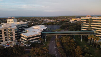 Ariel View sunset, sunset over empty parking lot,  
with random cars road