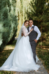 Fototapeta premium young couple the groom in a plaid suit and the bride in a chic white dress