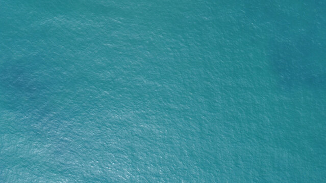 Blue water texture. Top view of the ocean surface with waves