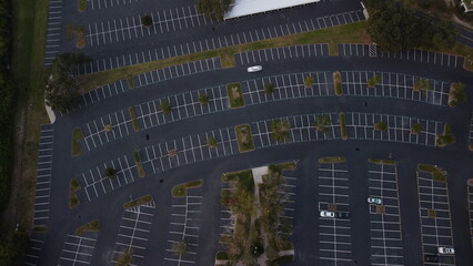 Fototapeta premium Ariel View sunset, sunset over empty parking lot, with random cars road