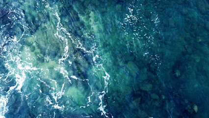 Blue water texture. Top view of the ocean surface with waves