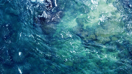 Blue water texture. Top view of the ocean surface with waves