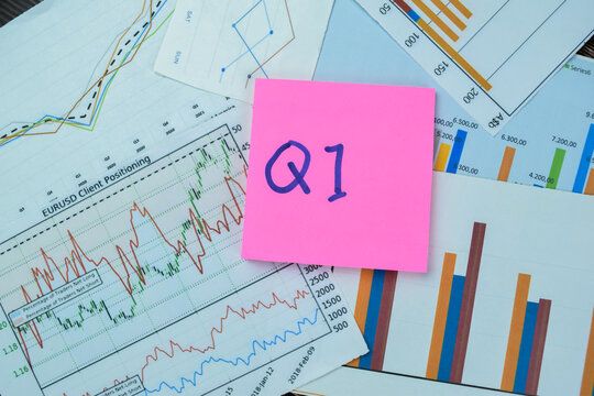 Concept of Q1 - 1st Quarter Period write on sticky notes isolated on Wooden Table.