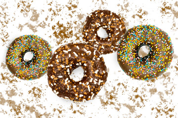 Flying falling levitating floating brown sweet sugar glazed doughnuts,tasty donuts in air on white spotted painted abstract background.Creative dessert food.Trendy,unhealthy nutrition,mockup