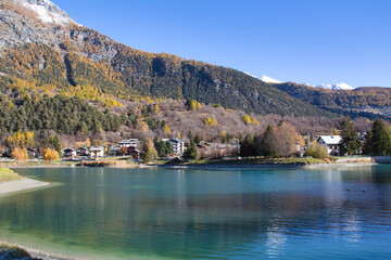 Fototapeta na wymiar Brusson lake in autumn. Ayas valley, Italy.