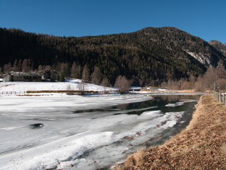 Fototapeta na wymiar Around Brusson lake in winter. Ayas valley, Italy