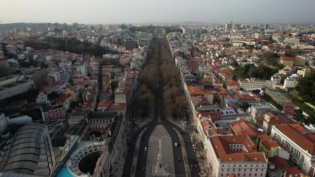 Aerial drone view of Rossio Train Station and Restauradores Square leading up to Avenida da Liberdade in Lisbon, Portugal
