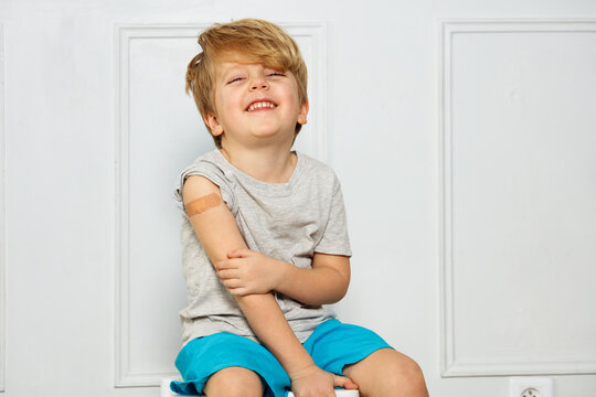 Laughing Handsome Little Boy With Band-aid On His Shoulder