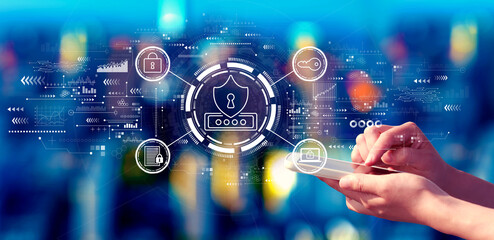 Cyber security theme with person using a smartphone in a city at night