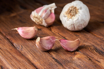 Garlic on the brown wooden table.