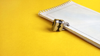 Notepad on a spring closed with a small padlock