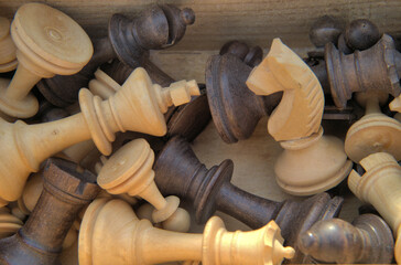 vintage wooden pieces used in the game of chess. Closeup shows the knight, a king, pawn and bishop. Wood is walnut and maple.