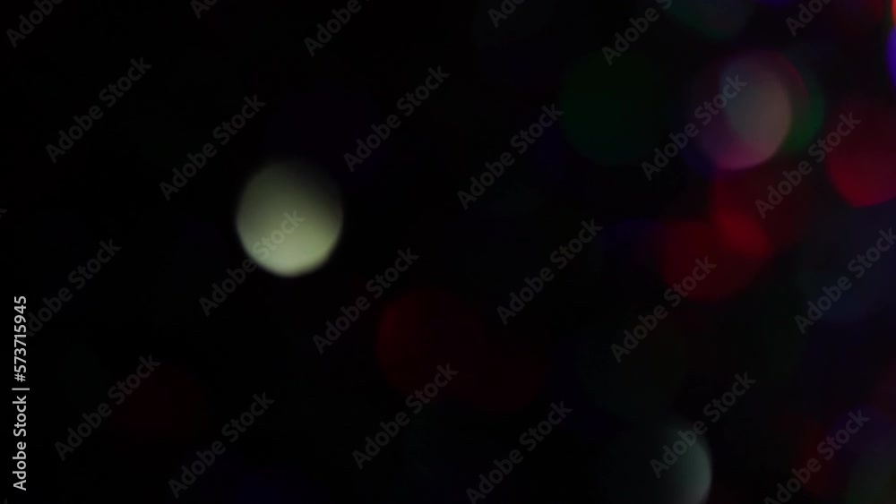 Wall mural abstract bokeh lights, colorful bokeh transition on black background. blurred lights glow. colorful 
