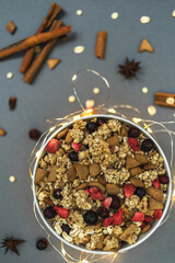 A diet breakfast with a high protein content. Crispy muesli, granola with strawberries, black currants and white chocolate. View from above.