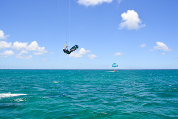 A kite surfer riding waves of Caribbean sea. 