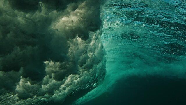 Slim woman surfer rides the wave. Woman surfs the ocean wave in the Maldives on yellow longboard