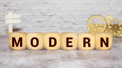 Modern model symbol. Businessman turns wooden cubes and changes the word 'model' to 'modern'.