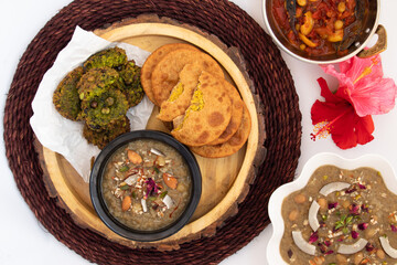 Dal Bhari Poori, Dholl Puri, Cholar Dal, Luchi Served With Gur Ki Kheer Or Jaggery Rice Pudding, Nolen Gurer Payesh, Rasiya, Payasam, Hara Chana Or Chholia Pakoda Bhabhra, Tamatar Ki Meethi Chutney