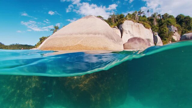 Splitted underwater view of the rocks and sea bottom. Campeche island in Florianopolis in Brazil