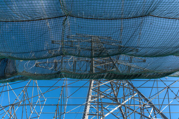 A newly installed high-voltage pylon with some cables connected