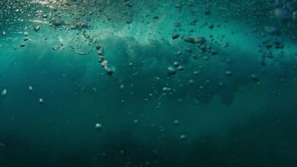 Girl surfer rides the wave. Woman in red suit surfs the ocean wave in the Maldives