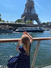 Adorable preschooler girl anjoying the view from tourist boat floating on Seine in Paris