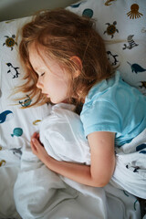 Preschooler girl sleeping in her bed