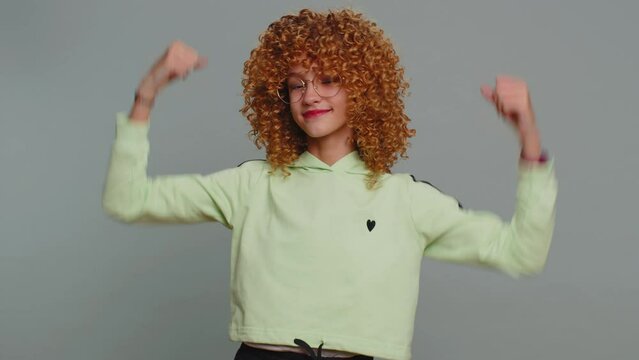 I am the best. Happy satisfied selfish haughty teen girl in glasses proud of her victory, bragging own success win achievements, pointing fingers on herself with smile. Child kid on gray background