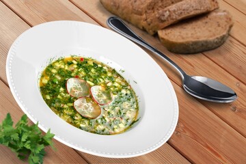 Tasty fresh soup dish in plate with bread