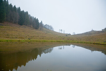 Foggy landscape from Asiago plateau trekking path